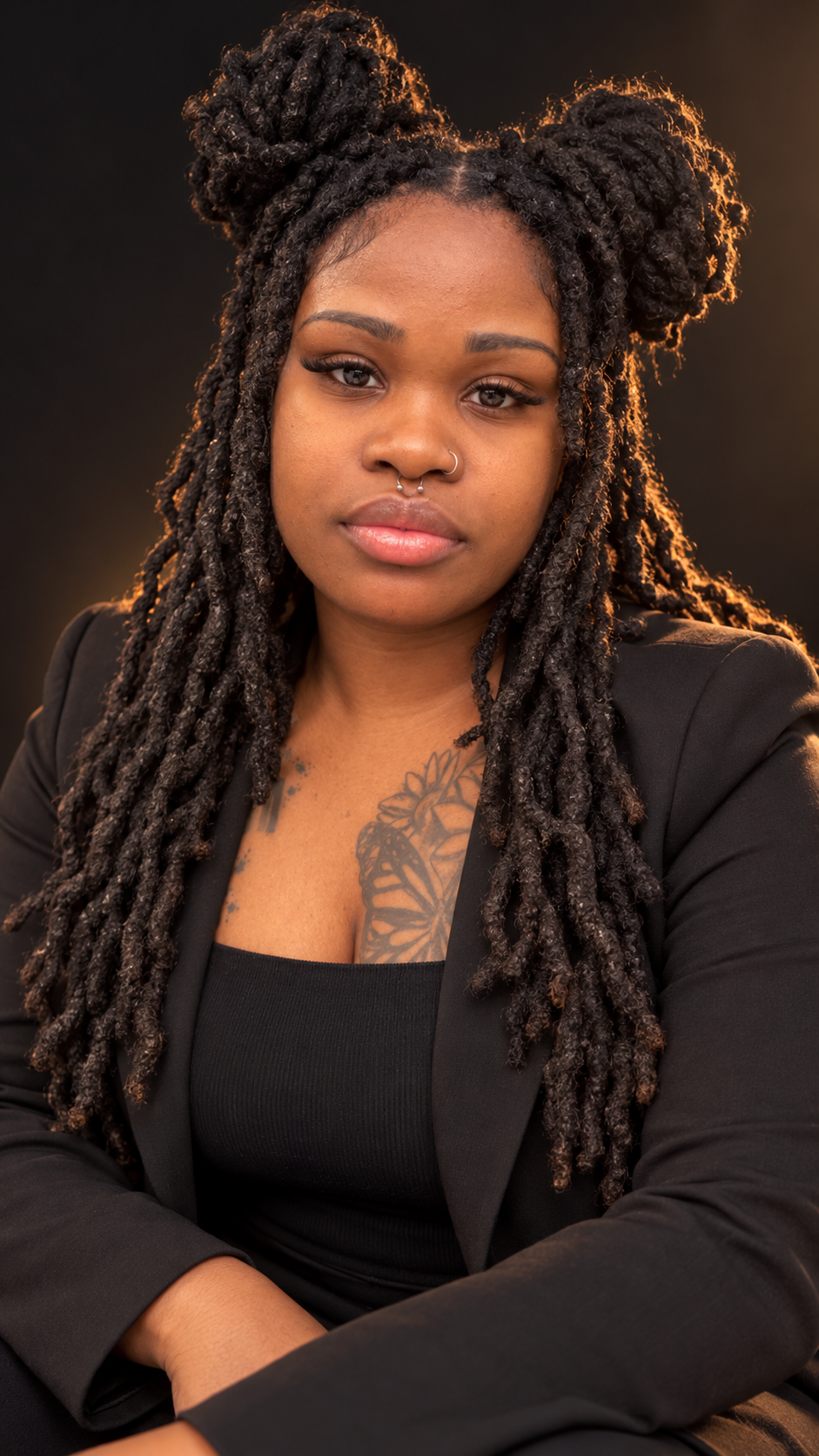 Editorial portrait of Wendy Empress Peters with locs and a black jacket